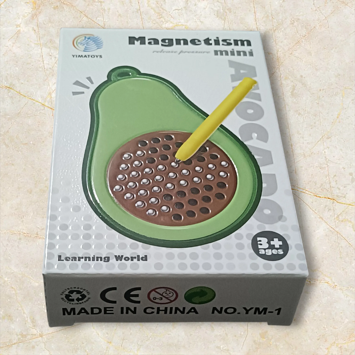 Box of an avocado-shaped educational toy with 'Magnetism' branding on a beige surface.