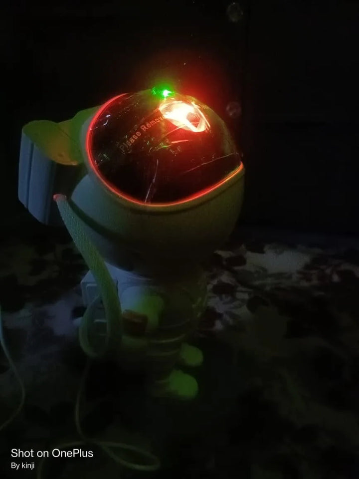 Toy robot with glowing red light on a dark background